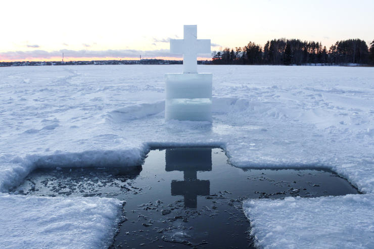 Holidays of Orthodox baptism. Ice cross hole and a cross of the feast Epiphany